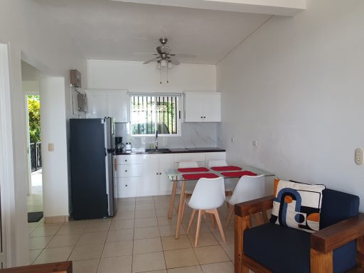 fully equipped kitchen with refrigerator and freezer and dining room in Villa Hermosa Claudia, Playa Hermosa, Jacó, Costa Rica
